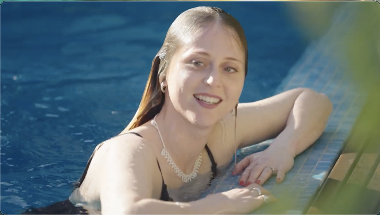 Woman enjoying a luxurious pool designed by Luxpool, highlighting elegance and comfort.